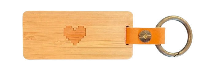 Back of the KEEP keychain — FSC bamboo body with an engraved pixel heart.